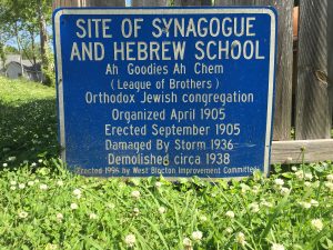 Sign reading "Site of Synagogue and Hebrew School"