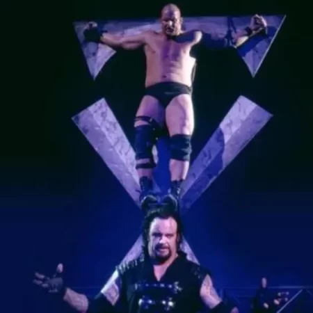 "Stone Cold" Steve Austin hangs on a cross-shaped icon high above the head of the Undertaker.
